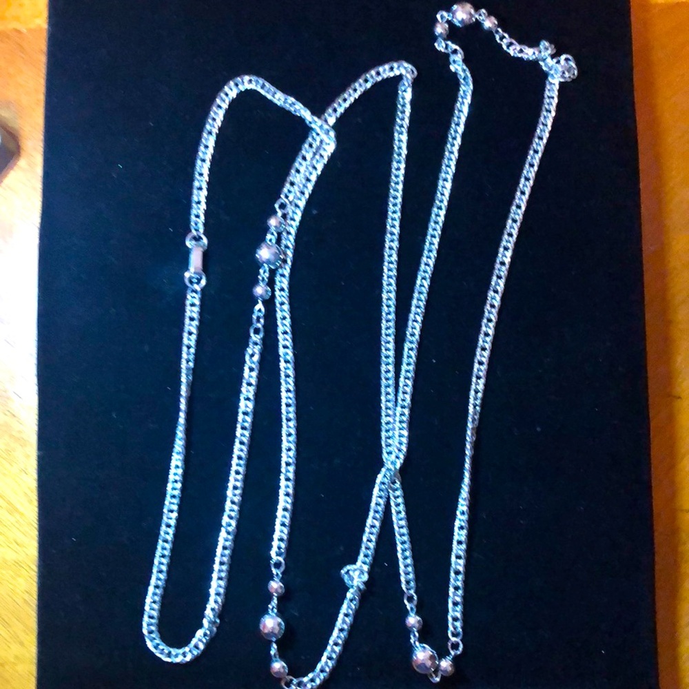 Gorgeous long silver tone necklace.